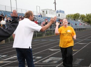 photo by Carolyn Bertsch Athlete Amy Olson from Sauk Rapids and Joe Perske, Sartell Middle School phy-ed teacher and Special Olympics volunteer, exchange a high five at the finish line of the 800-meter walk during the Special Olympics Track and Field Meet, held at the Sartell Middle School on Saturday, May 16. 21 teams, including the St. Cloud Area 7 Team which is comprised of athletes residing in St Cloud, Sartell, Sauk Rapids, St. Joseph, Waite Park, Clear Lake, Clearwater, and Rockville, participated in field events, including Long Jump and Bocce, and track events including running, walking, and relays. 