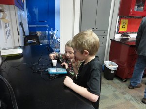 photo by Cori Hilsgen ASA first-grade students Maleah Thielen (left) and Austin Baird check the temperature of snow  in the SCSU Science Express. 