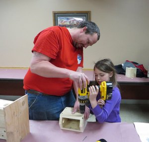 photo by Cori Hilsgen Chris Westerhoff helps his daughter, Morgan, 7, put together a birdhouse. 