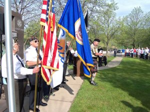 photo by Dennis Dalman Bagpiper Joe Linneman plays a tune while the American Legion Color Guard of Sartell stands ready. 