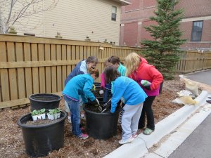 photo by Cori Hilsgen Second-grade-teacher Betty Pundsack and students work on garden containers during the ASA Spring Showcase. Pictured (left to right) are fourth-grader Mary Morris; Betty Pundsack; second-grader Gabriella Morris; and fourth-graders Alaina Botz, Emma Kremer and Claire Sia Su. 
