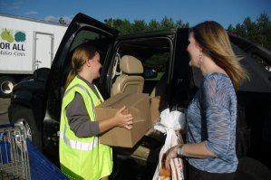 photo by Logan Gruber Natalia Gall, left, helps Carissa Hopkins of St. Cloud load groceries into her car at Resurrection Lutheran Church. Hopkins heard about "Fare for All" from a co-worker this summer, and has been coming ever since. Gall is a senior at the College of St. Benedict, and is volunteering through the AKS sorority.