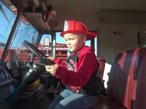 photo by Dennis Dalman Jacob Bonfield of Sartell plays pint-sized firefighter at the Sartell-LeSauk Fire Department's Open House Oct. 9.