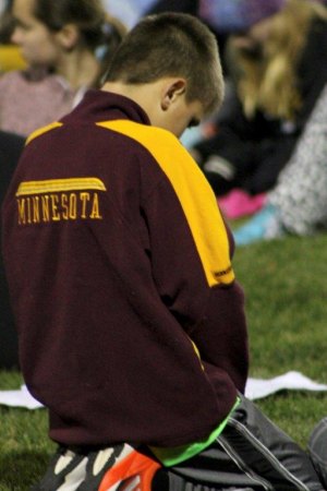 contributed photo by Madi Sorensen  A Sartell student prays during Fields of Faith on Oct. 8 at the Sartell Football Field.