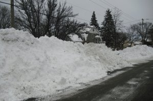 photo by Logan Gruber Mounds of snow could be seen all over town in the middle of the street.  This pile sits on West Ash Street, near the city offices.