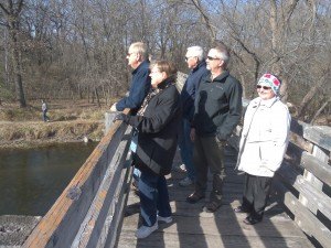 photo by Dennis Dalman A tour group, all members of Unity Spiritual Center in Sartell, pause for a view at the walking bridge that connects Sauk River Regional Park to Whitney Park in St. Cloud. From left to right are tour guide Steve Hennes, Sartell; Kris Bahl, St. Cloud; Duane Nieters, Rice; Dan Haskamp, Sartell; and Ruth Duhamel, Oak Park.