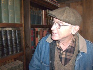 photo by Dennis Dalman Jerry Hansen glances at some of the many books lined up neatly on his long rows of bookshelves.