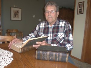 photo by Dennis Dalman Gilbert Stock peruses the two big history books he intends to donate to the St. Joseph Area Historical Society. Now 83, Stock, who grew up on a farm a few miles east of St. Joseph and still lives there, has always had a loyalty and soft spot for the City of St. Joseph. 