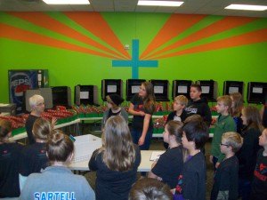 contributed photo  Patsy Magelssen, left, instructs children at Celebration Lutheran Church about their collection and packaging of toys and comfort items for poor children in other countries.