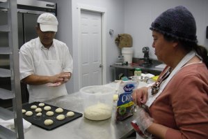 photo by Logan Gruber Tahir Sandhu and Gwen Williams work as a team while making cup-naan Monday evening in their new bakery.
