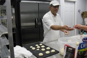 photo by Logan Gruber Tahir Sandhu and Gwen Williams work as a team while making cup-naan Monday evening in their new bakery.