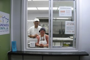 photo by Logan Gruber Tahir Sandhu and Gwen Williams pose in the window of their new bakery in the northeast corner of Minnesota Street Market.