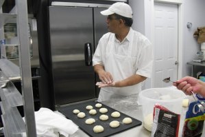 photo by Logan Gruber Tahir Sandhu presses cranberries into cup-naan Monday evening to make samples for customers.