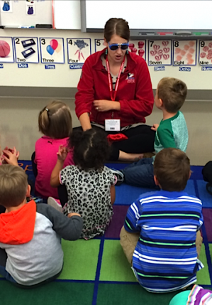 contributed photo Kara Rud plays "What is it?" with her pre-school students at Kennedy Community School. The children sing the "What is it?" song and then Kara pulls an object out of a hat in this case the pair of Mickey Mouse sunglasses she is wearing. Then the children discuss the object. Pictured Aubrey Plautz (upper left), Ethan Whitehead (upper right), Luci Novak (middle), Even Robinson (lower left) and Tanner Skaalerud (lower right).