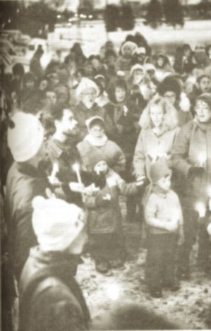 photo by Stuart Goldschen Patty and Jerry Wetterling (in white stockings caps) sing out to their hundreds of area supporters at a candle and song rally for their abducted son, Jacob, at Lake George, Nov. 18.