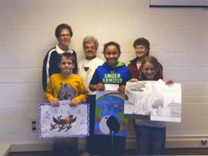 contributed photo St. John's Preparatory School peace poster contest winners are as follows (front row, left to right): Jackson Kirby, third place; Valeriya Woodard, first place; and, Cathie Sikes, second place; (back row) St. Joseph Y2K Lions Bernie Heurung, Delrose Fischer and Ann Reischl.  Valeriya's poster was forwarded on to the district competition. The contest encourages young people, ages 11-13, to think about peace, creatively express what it means to them and to share their own unique visions with the world.  