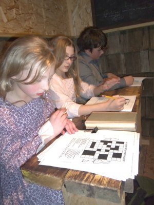 photo by Dennis Dalman Three students contemplate their lessons in the schoolroom during Ebenezer, a Christmas Walk at the Living Waters church in Sartell. At left is Belle, the sweetheart of Ebenezer Scrooge when he was a boy. 