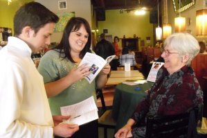 photo by Logan Gruber St. John's University senior, Ben Hutterer, and College of St. Benedict Senior, Katie Tillman, paged through the new book, Laugh Yourself Happy: Kids Say Delightful Things, written by Linda Hutchinson, right, on Dec. 6 during her book-signing at the Local Blend.