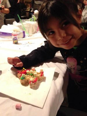 contributed photo Feliciana Santiago, St. Joseph, decorated gingerbread rice crispy bars at Little Saints Academy's Holiday Social. There were many arts, crafts and games for the children to participate in.
