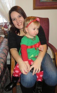 photo by Cori Hilsgen Amelia Curtis, 2, sat on her mother, Alana Curtis', lap while keeping an eye on "Santa." 