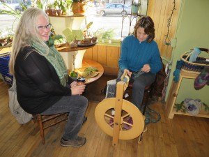 photo by Cori Hilsgen Sandy Millerbernd (right) visits with Minnnesota Street Market general manager Patricia Benson while spinning some sheep fiber. 