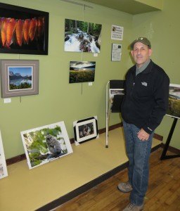 photo by Cori Hilsgen Photographer Tony Peroutky discusses where some of his photos were taken during the Dec. 6 local artists sale. 