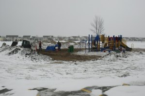 photo by Logan Gruber Workers install a new, safe and age-appropriate playground behind Colts Academy. 