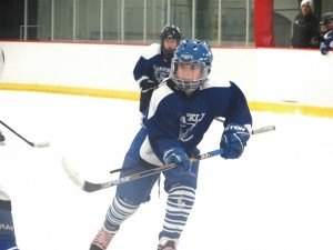 contributed photo Corey Hansen, a member of the Sartell Squirts A team, glides across the ice of the Bernick’s Arena, his eye intently on the puck. 