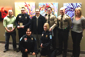 photo courtesy of Alex Svejkovsky, WJON-Radio. The Lifesaving Award recipients are (first row, left to right) Shelby Lane and Kari Bonfield, both of the Sartell Police Department; (second row) Dan Williams, trauma employee at St. Cloud Hospital; Johnathan Batterberry, Becker police officer; Ernie Kociemba of Grey Eagle, the man who suffered a heart attack; Dusty Miller, Wright County deputy; Zach Sorenson, Stearns County deputy; and Nancy Kalla, emergency medical technician for Gold Cross Ambulance Service. 