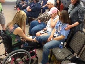 contributed photo Tiffany Johnson does a healing exercise with an audience member at one of her many appearances. Johnson, a psychic-medium, has loyal followers through the world.