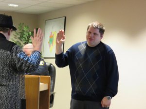 photo by Logan Gruber New council member Matt Killam takes his oath of office at Monday night's city council meeting, given by City Administrator Judy Weyrens.