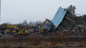 photo by Logan Gruber One of the last remaining pieces of the paper mill in Sartell fell on January 21. The next day, several large excavators were on hand to begin moving the rubble off-site.