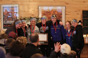 photo by David Eickhoff The ski team poses for photos while holding their second place plaque and wearing their well-deserved medals on Feb. 3 after defeating Little Falls at MapleLag near Detroit Lakes.