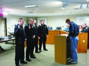 photo by Logan Gruber Mayor Schultz swore the new reserve officers into service during the Feb. 2 city council meeting. 