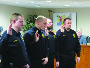 photo by Logan Gruber The four new reserve officers took their swearing in very seriously at the Feb. 2 city council meeting.