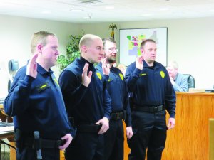 photo by Logan Gruber The four new reserve officers took their swearing in very seriously at the Feb. 2 city council meeting.