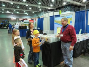 photo by Cori Hilsgen Freeport resident Mandy Welle  and her children stopped at the Cy Pfannenstein music booth to have him sign their bingo sheet. Pictured (clockwise) are Alex, 4, Hannah, 9, Welle holding Lucy, 5 months, and Jack, 7.  