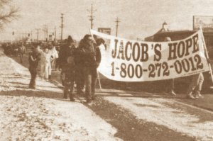 photo by Stuart Goldschen Some 50 marchers for Jacob Wetterling walk down Division Street in Waite Park on an eight-mile march from St. Cloud to St. Joseph on Feb. 24.