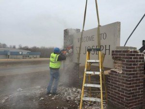 contributed photo Employees of Artistic Stone & Concrete dismantled the "Welcome to St. Joseph" sign between Old Hwy 52 and Hwy 75 on March 19. The sign was put into storage by the city.