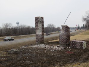 photo by Logan Gruber The final demolition of the above-ground portion of the sign had to wait until Monday, after power and gas lines in the ground were found and marked.