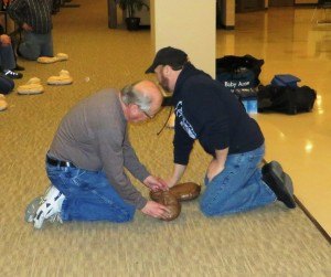 photo by Cori Hilsgen Instructors Bob Kempenich (left) and Mike Hengel demonstrate cardiopulmonary resuscitation and mouth-to-mouth breathing on a manikin during a recent Bystander CPR class at Heritage Hall. Both are sudden-cardiac-arrest survivors. 