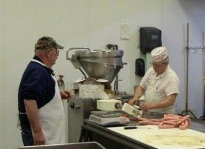 contributed photo A pre-workshop convention was held in the St. Joseph Meat Market sausage kitchen before the 75th annual convention of the Minnesota Association of Meat Processors, held in March at the River's Edge Convention Center in St. Cloud. Jon Christenson from Erdman's County Market in Kasson (left) prepared marinated trip tips and cooked brats while Rich Pfannenstein (right) operated the sausage stuffer. 