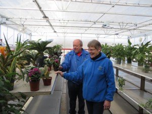 photo by Cori Hilsgen Ellen (front) and Tom Woods of Woods Farmer Seed & Nursery stock their new greenhouse with house plants. They opened their new location of Feb. 26 in Waite Park. 