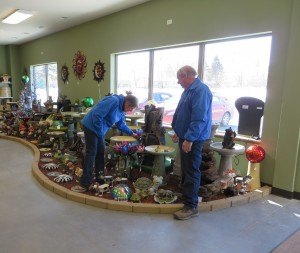 photo by Cori Hilsgen Ellen Woods (left) places a product in their new showroom while Tom Woods watches. The Woods said they have received many positive comments about their new showroom. 