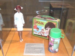 photo by Dennis Dalman A doll, lunchbox and thermos were commercial spin-offs of Julia, the first TV show starring a black actress, which was broadcast from 1968-1971. In the series, actress Diahann Carroll played a nurse. This display can be seen in For All the World to See, a new exhibit at the Stearns History Museum.