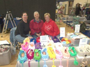 photo by Dennis Dalman Three sisters sell knitted and beaded items at one of the vendor booths at the Pine Groove Festival April 25 at Sartell Middle School, an even to raise funds for the Sartell Music Association. The name of the business is Jannel’s Crafts, owned by Jannel Harris (left) of Robbinsdale, formerly of Sartell. Her sisters, who both live in Sartell across the street from each other, are Julie Hiivala (middle) and Jon Marie Larson. 
