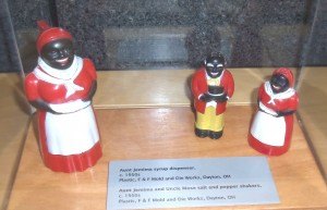 photo by Dennis Dalman These figurines, based on the iconic "Aunt Jemima" pancake products, include a syrup dispenser (left) and salt-and-pepper shakers (right). The "male" shaker is supposed to be Aunt Jemima's husband and resembles the demeaning "Stepin Fetchit" character so often depicted in movies before the Civil Rights Era. This is one of the many exhibits in "For All the World to See," now showing at the Stearns History Museum.