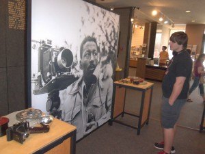 photo by Dennis Dalman A giant photo of Gordon Parks dominates in the exhibition entitled "For All the World to See" at the Stearns History Museum. Parks was one of the nation's great photographers. At right is museum visitor Austin Eastwood of St. Cloud.