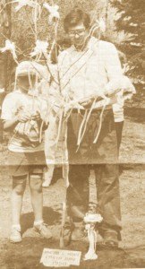 photo by Stuart Goldschen Jerry Wetterling and son, Trevor, tie Jacob's Hope ribbons on newly-planted ash tree for Jacob behind the Friends of Jacob office in St. Joseph during ceremony on April 20.