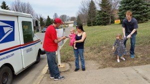 photo by Logan Gruber U.S. Postal Service delivery driver Todd Ruegemer, Cold Spring, had the honor of delivering the book to Layla Hawkins, 15 months.